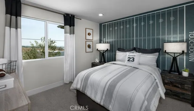 a bed sitting in a bedroom next to a window