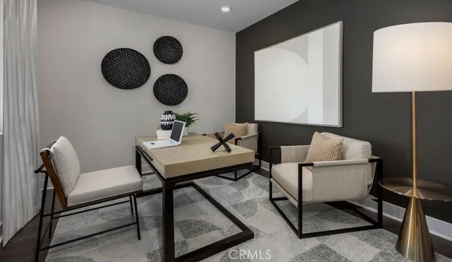 a living room with chairs and a mirror