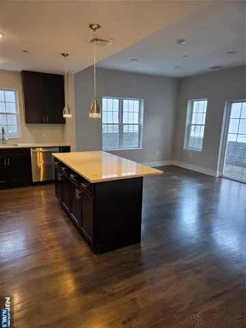 a large kitchen with stainless steel appliances granite countertop a stove a sink and a microwave