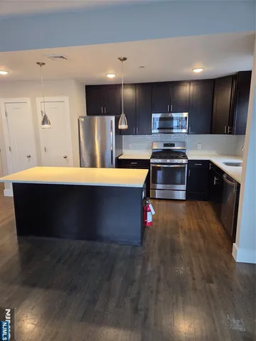 a kitchen with stainless steel appliances wooden cabinets and granite counter tops