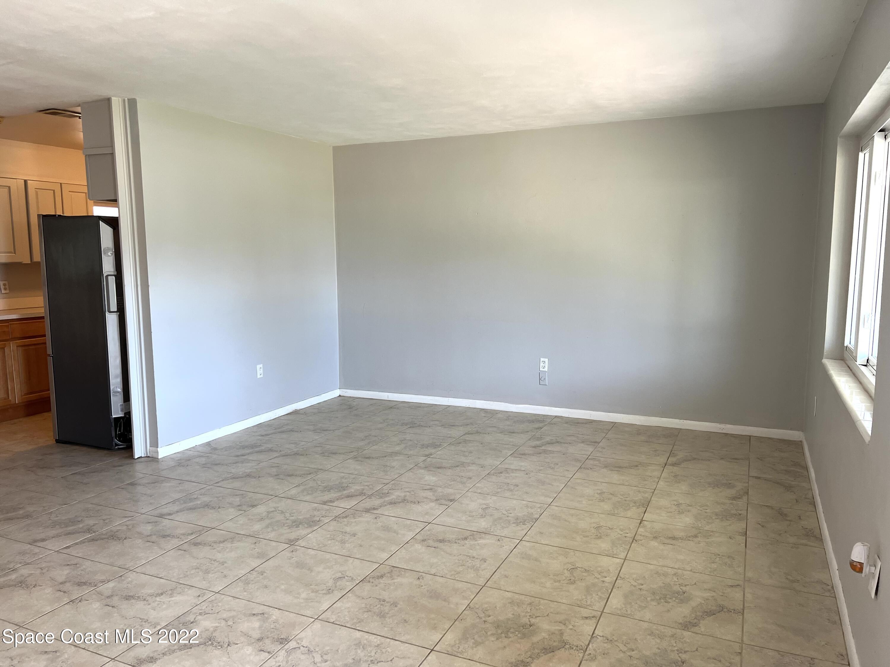 282 Fay Drive Indialantic, FL 32903 - Photo 12 of 27 an empty room with windows