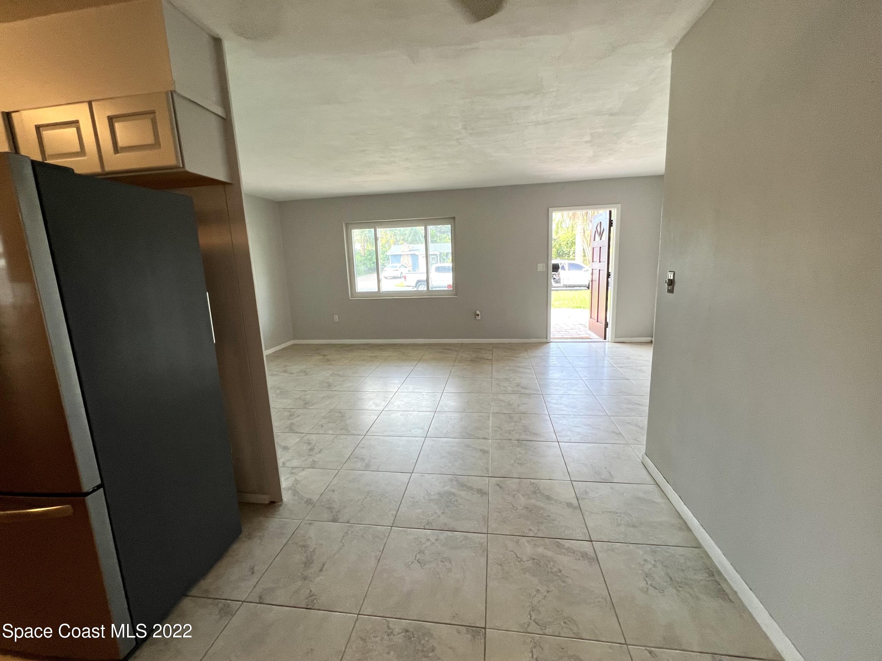 282 Fay Drive Indialantic, FL 32903 - Photo 13 of 27 an empty room with windows and entrance