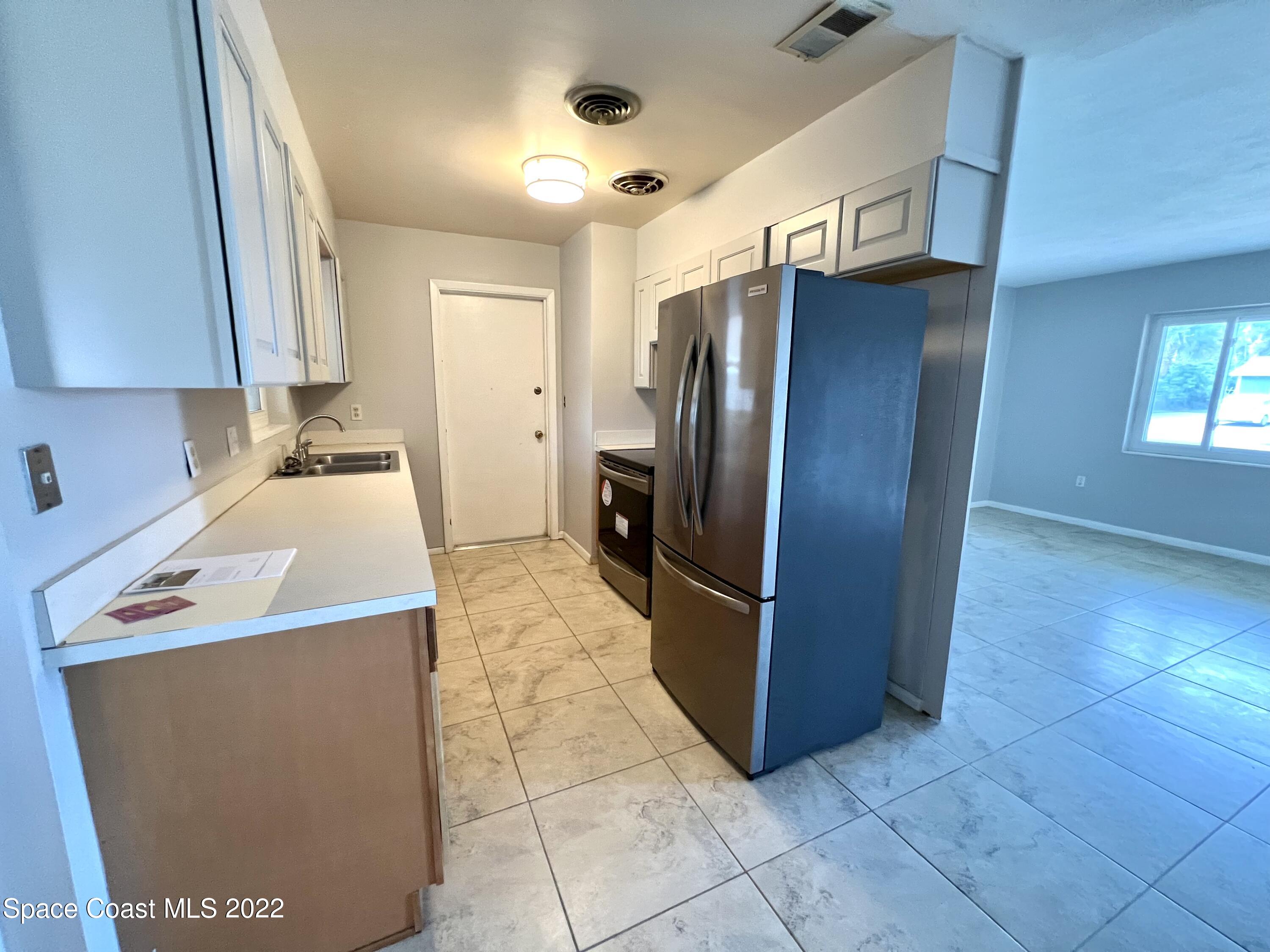 282 Fay Drive Indialantic, FL 32903 - Photo 14 of 27 a kitchen with stainless steel appliances a refrigerator and a sink