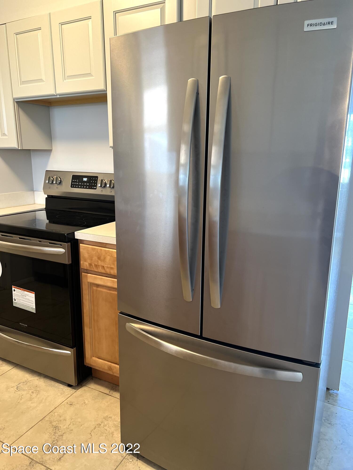 282 Fay Drive Indialantic, FL 32903 - Photo 16 of 27 a metallic refrigerator freezer sitting in a kitchen