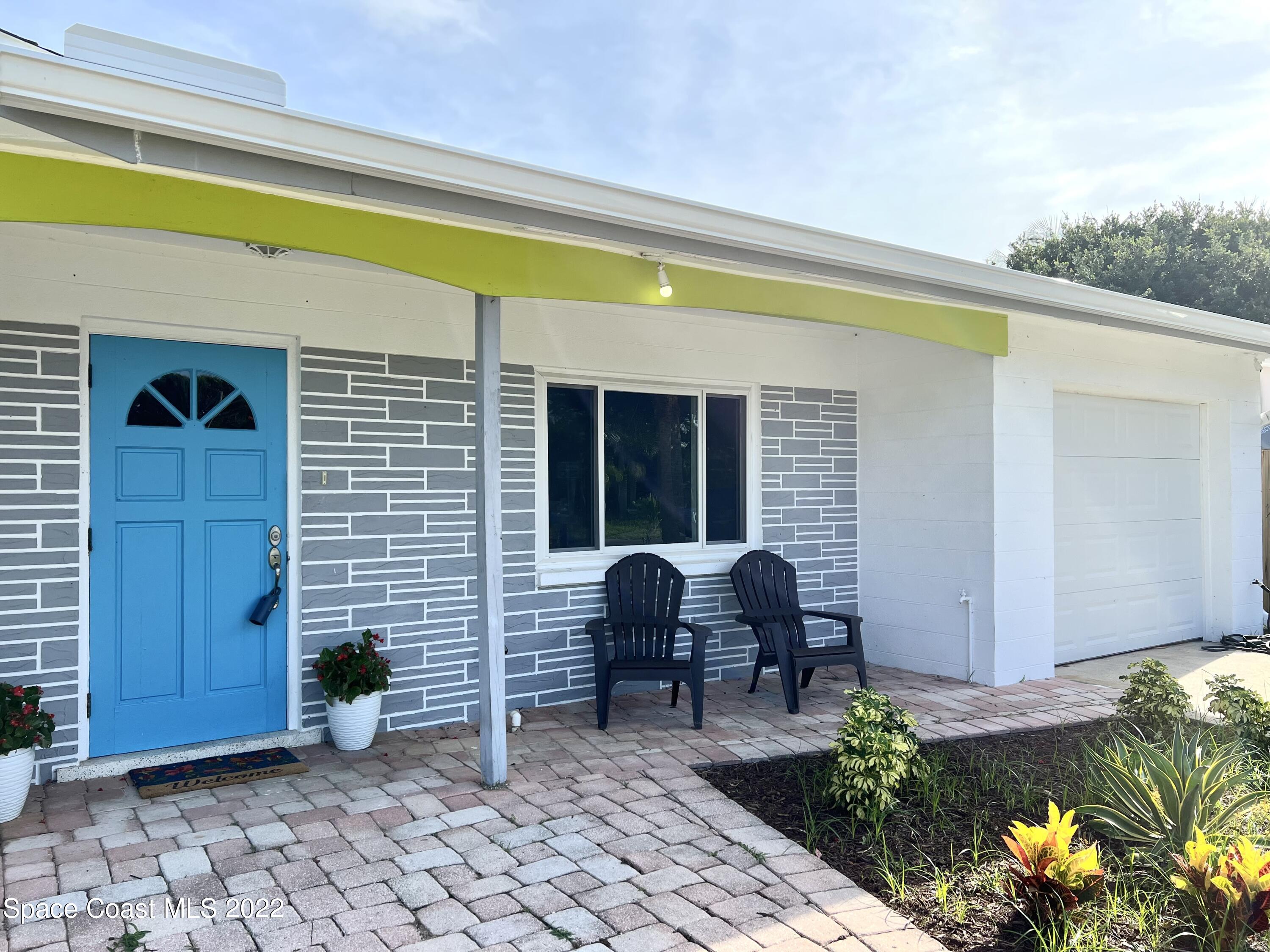 282 Fay Drive Indialantic, FL 32903 - Photo 2 of 27 a front view of a house with garden
