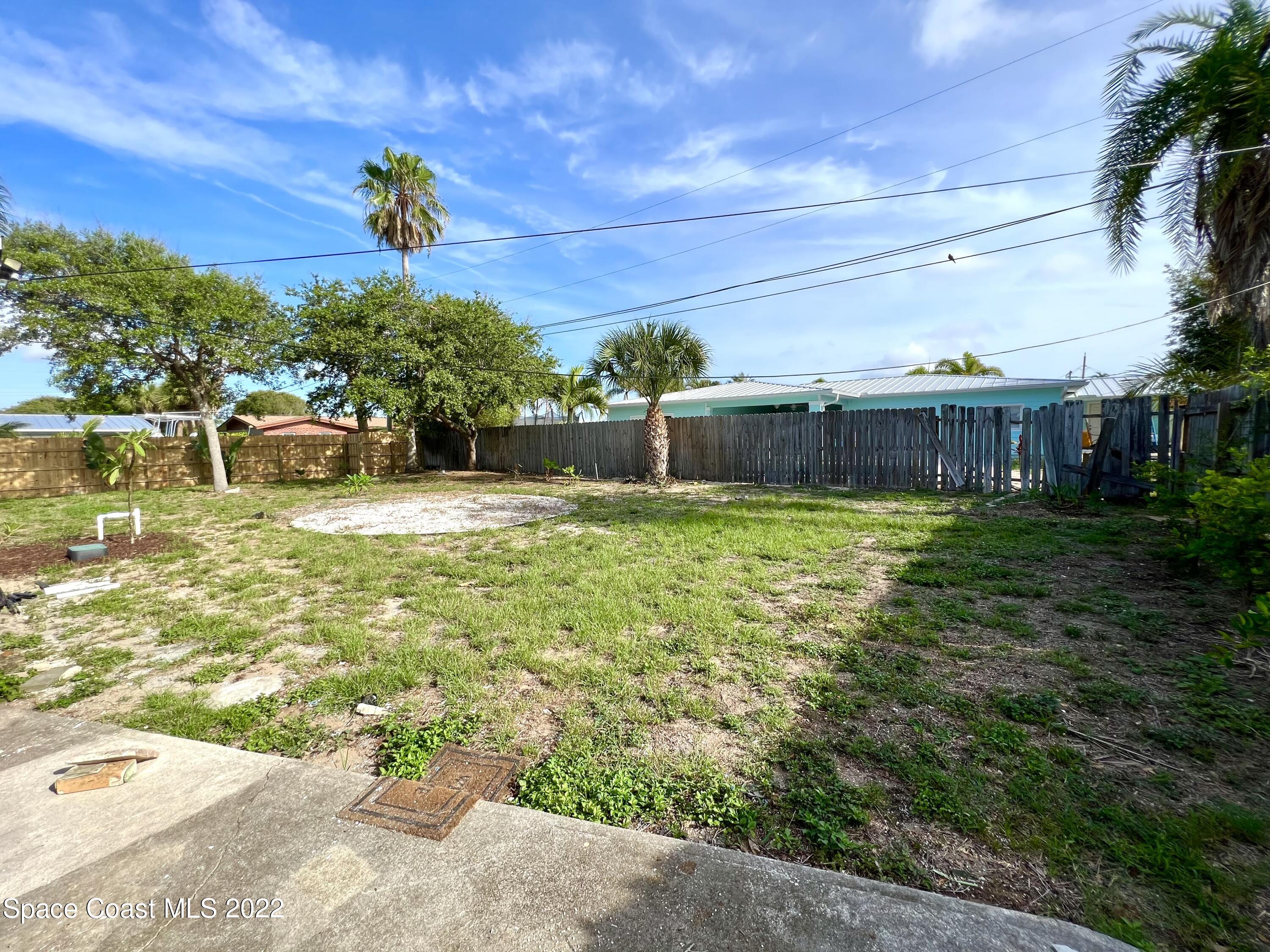 282 Fay Drive Indialantic, FL 32903 - Photo 26 of 27 a view of a swimming pool with a patio and a yard