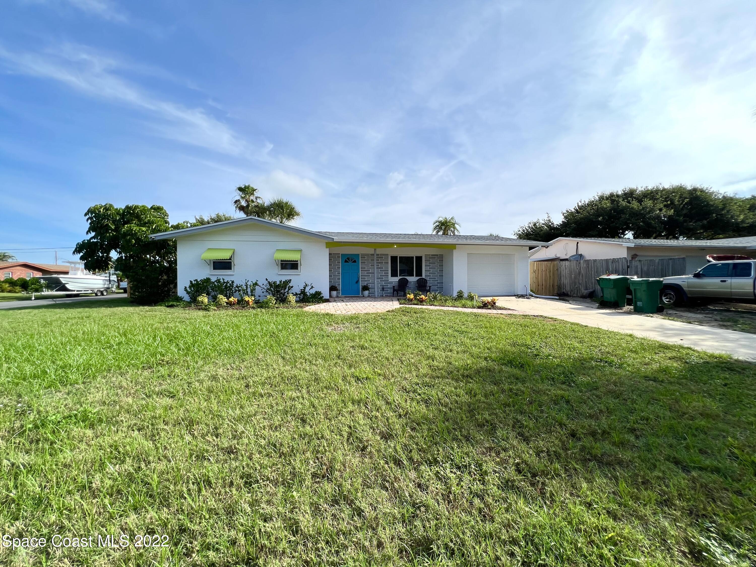 282 Fay Drive Indialantic, FL 32903 - Photo 3 of 27 a front view of a house with garden