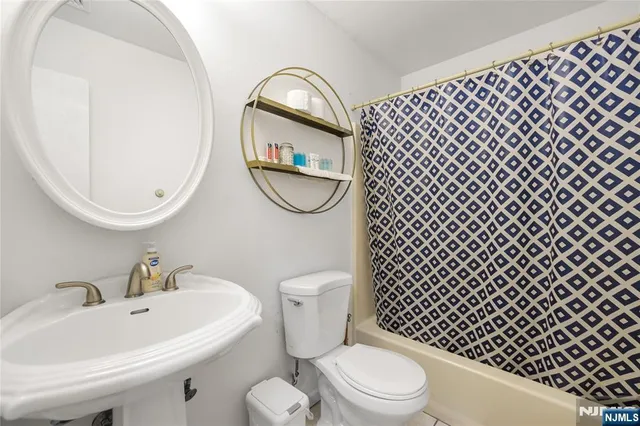 a white toilet sitting next to a bathroom sink