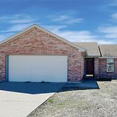a view of a house with a wooden fence