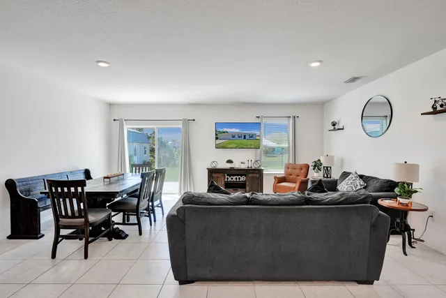 a living room with furniture a fireplace and a large window