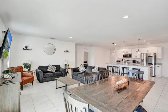 a living room with furniture and kitchen view