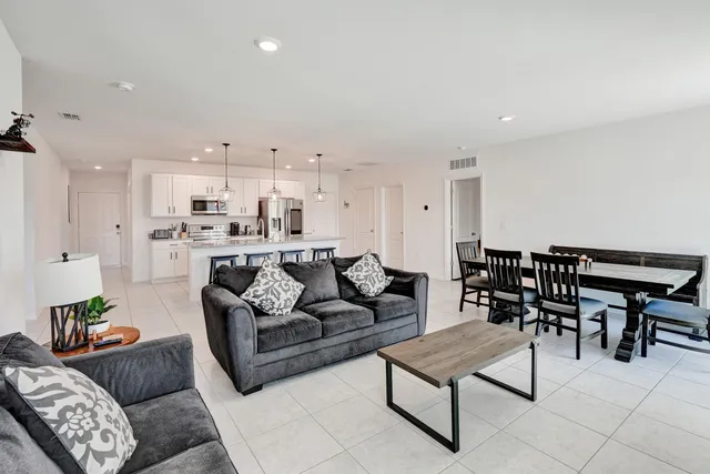 a living room with furniture and kitchen view