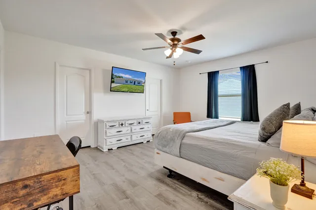 a bedroom with a bed and a chandelier