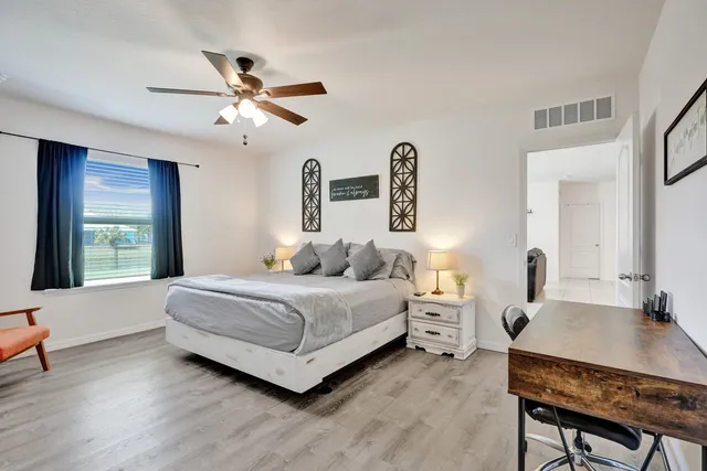 a living room with a bed furniture and a large window