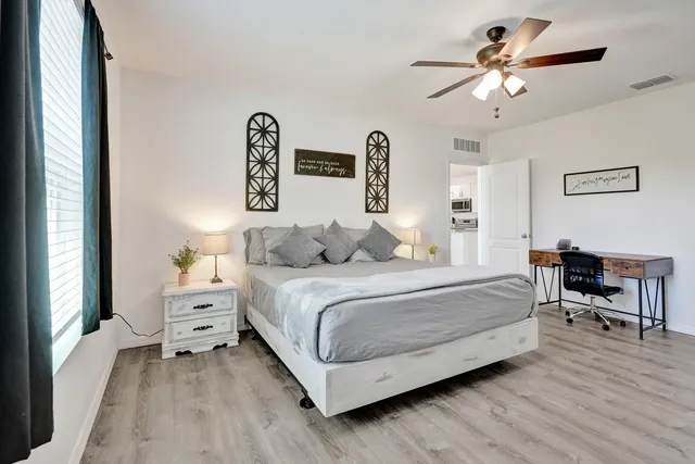 a bedroom with a bed and a chandelier