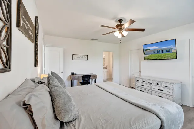 a bedroom with a bed and a chandelier