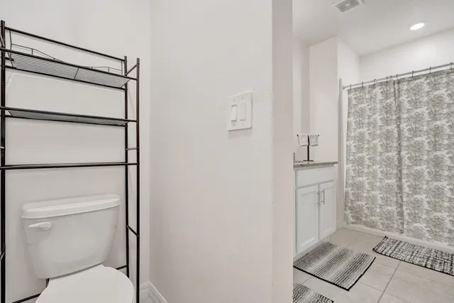 a bathroom with a shower toilet and sink