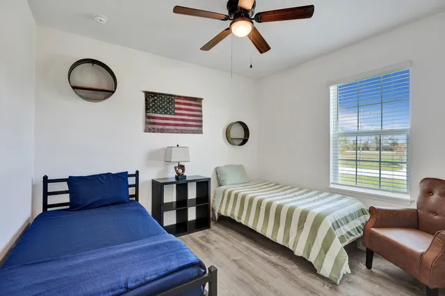 a bedroom with a bed furniture and a window