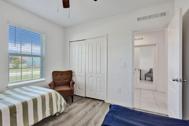 a bedroom with bed and window