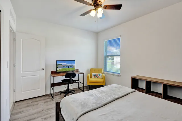 a bedroom with a bed and a chandelier