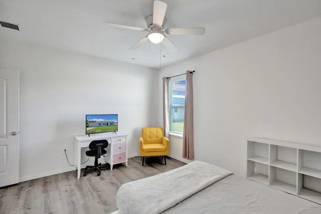 a bedroom with a workspace