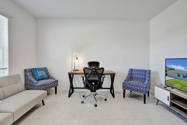 a living room with furniture and a potted plant