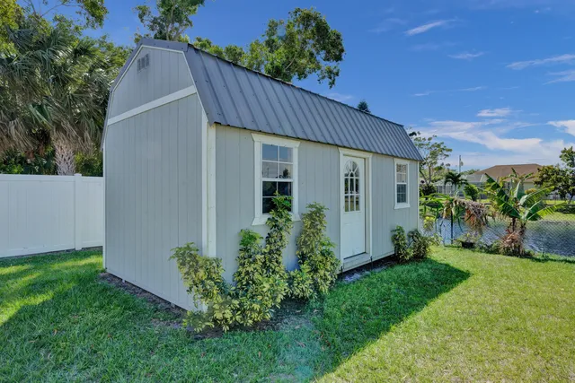 a view of a house with a yard and plants