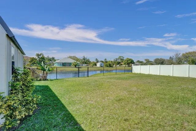 a view of a lake with houses in the back