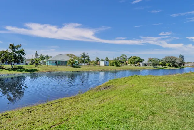 a view of a patio with table and chairs with wooden fence and plants