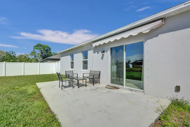 a aerial view of a house with swimming pool lawn chairs and a yard
