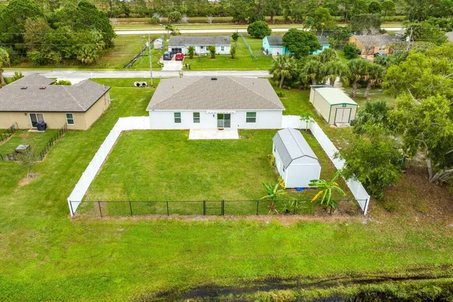 an aerial view of a house with a yard