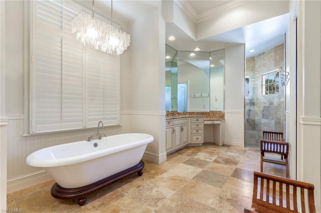 516 Portside Drive Naples, FL 34103 - Photo 18 of 33 a spacious bathroom with a double vanity sink a mirror and a shower