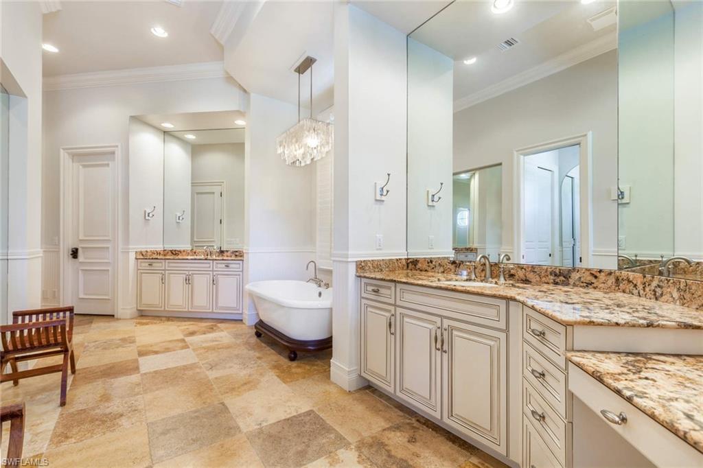 516 Portside Drive Naples, FL 34103 - Photo 19 of 33 a large bathroom with a granite countertop sink a toilet a mirror and shower
