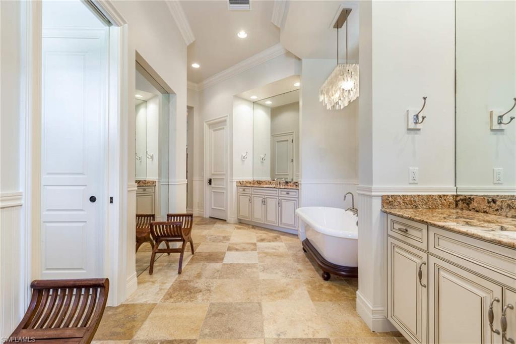 516 Portside Drive Naples, FL 34103 - Photo 20 of 33 a spacious bathroom with a granite countertop sink a toilet and a mirror