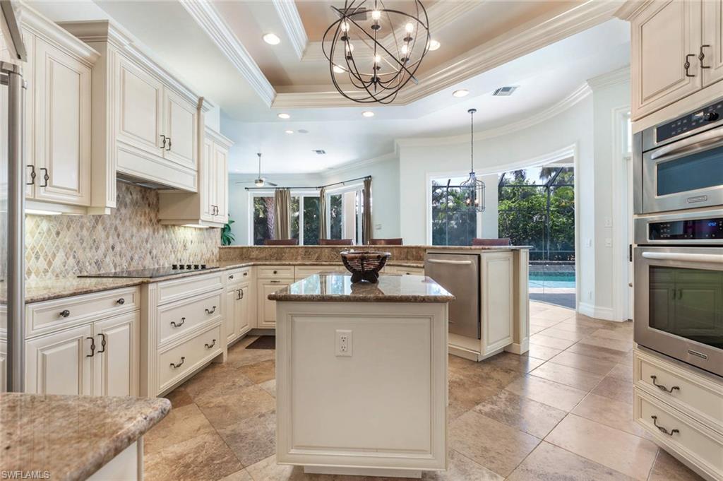 516 Portside Drive Naples, FL 34103 - Photo 23 of 33 a kitchen with stainless steel appliances granite countertop a sink and cabinets