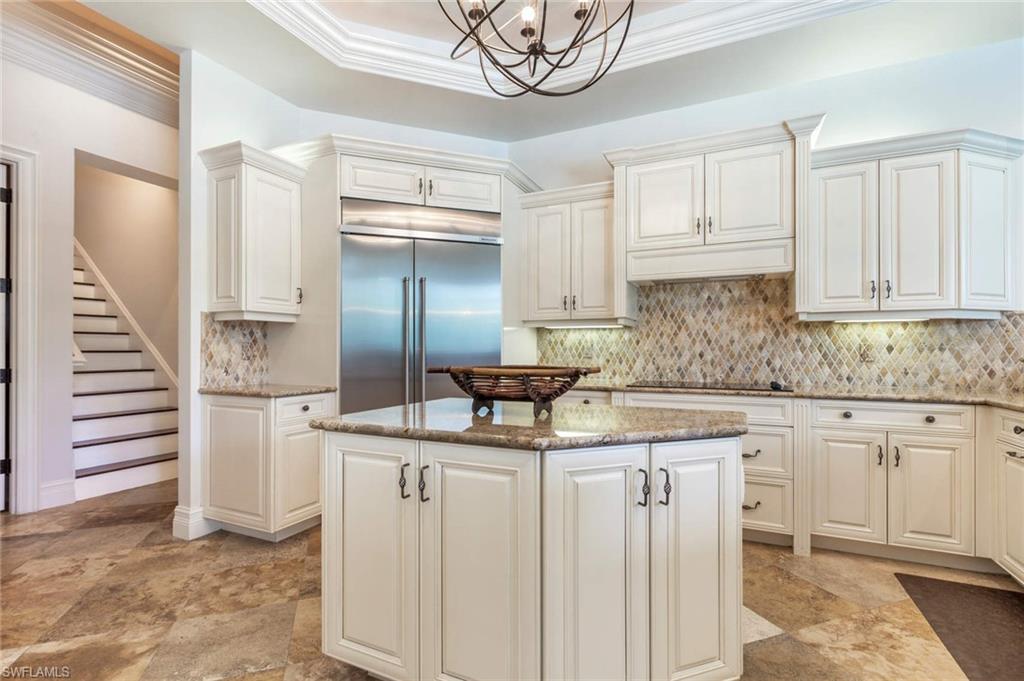 516 Portside Drive Naples, FL 34103 - Photo 24 of 33 a kitchen with stainless steel appliances granite countertop a sink and cabinets