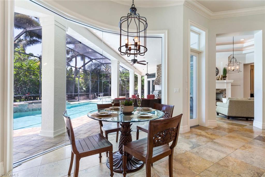 516 Portside Drive Naples, FL 34103 - Photo 25 of 33 a dining room with furniture a chandelier and a rug