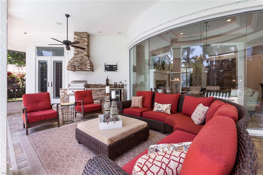 516 Portside Drive Naples, FL 34103 - Photo 29 of 33 a living room with furniture a lamp and a chandelier
