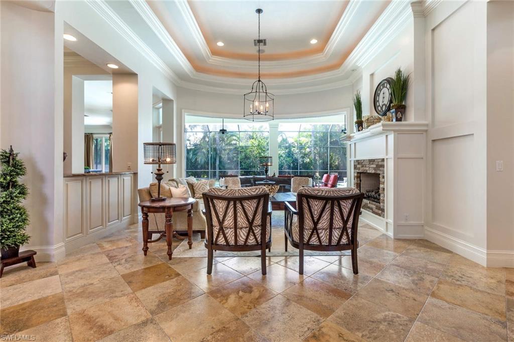 516 Portside Drive Naples, FL 34103 - Photo 3 of 33 a dining room with furniture a chandelier and a rug