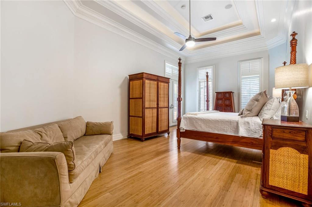 516 Portside Drive Naples, FL 34103 - Photo 33 of 33 a bedroom with a bed and wooden floor
