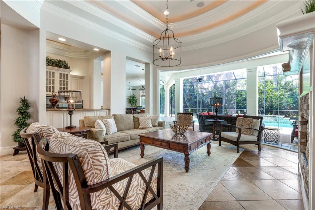 516 Portside Drive Naples, FL 34103 - Photo 5 of 33 a living room with furniture and a chandelier