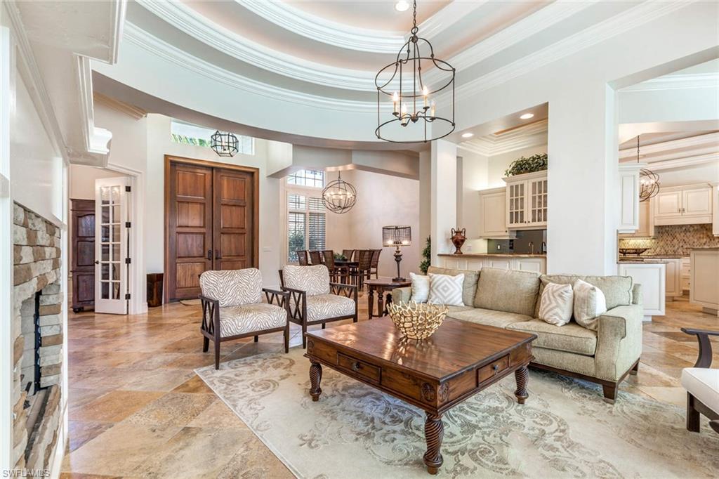 516 Portside Drive Naples, FL 34103 - Photo 6 of 33 a living room with fireplace furniture and a chandelier
