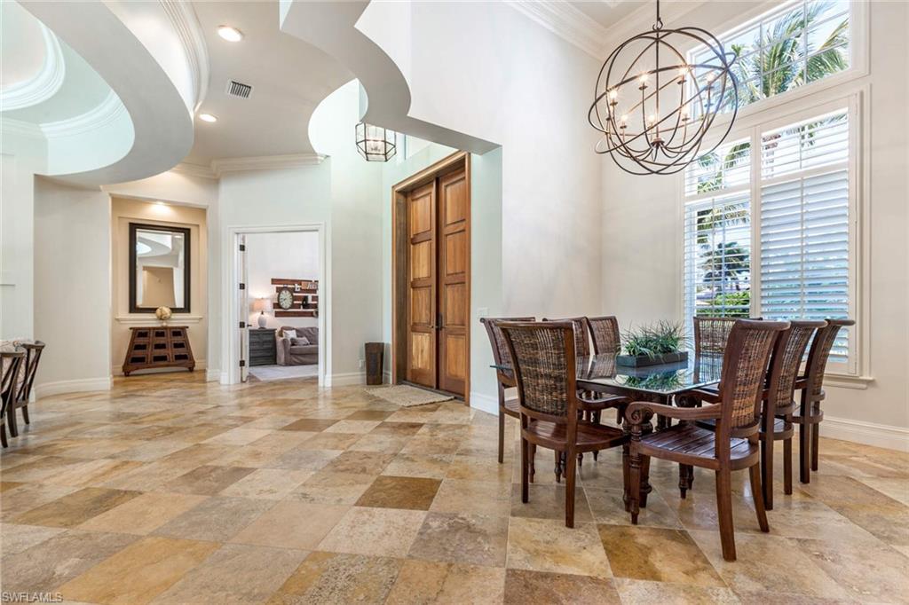 516 Portside Drive Naples, FL 34103 - Photo 8 of 33 a view of a dining room with furniture and a chandelier