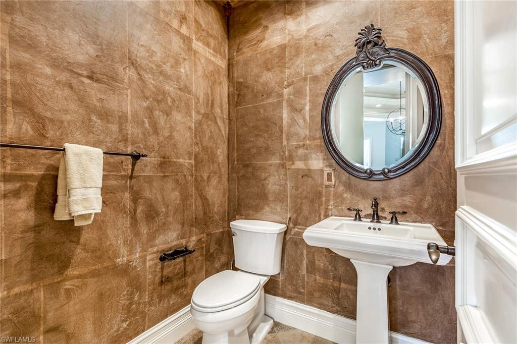 516 Portside Drive Naples, FL 34103 - Photo 9 of 33 a bathroom with a sink mirror toilet and shower