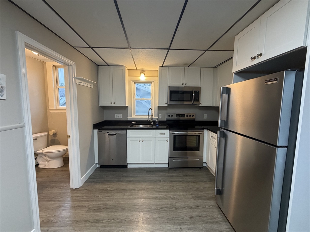 a kitchen with a refrigerator a stove top oven a sink and dishwasher