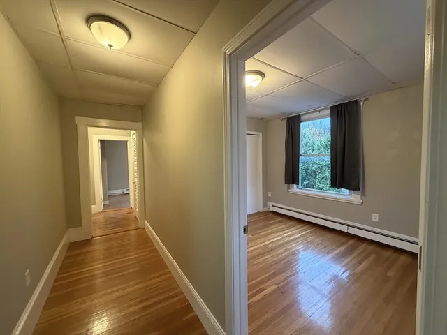 a view of a hallway with wooden floor