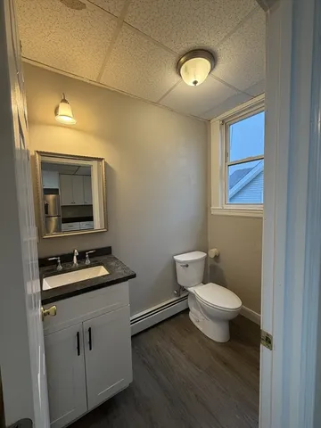 a bathroom with a toilet a sink and mirror