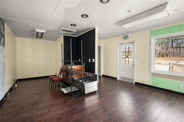 a view of a room with wooden floor and windows
