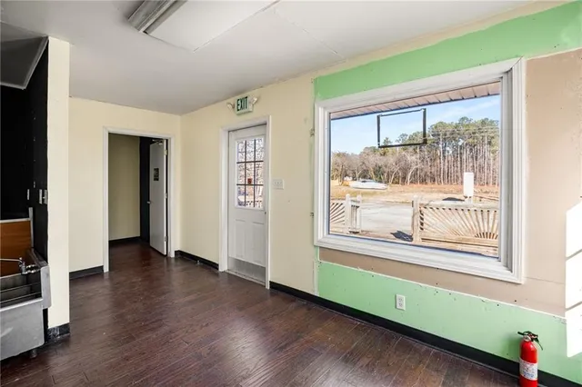 a view of a room with wooden floor and windows