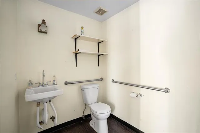 a white toilet sitting next to a bathroom sink